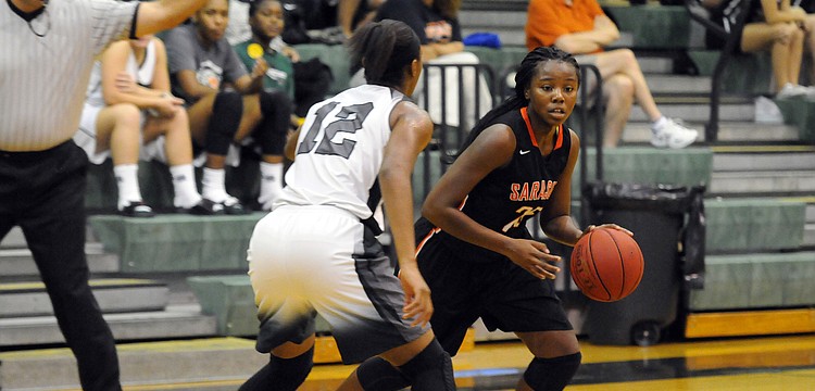 Sarasota's Ja'da Bennett attempts to dribble past Lakewood Ranch's Aleah Robinson.