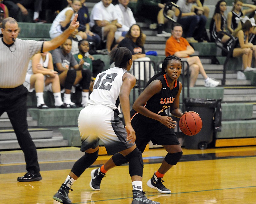 Sarasota's Ja'da Bennett attempts to dribble past Lakewood Ranch's Aleah Robinson.
