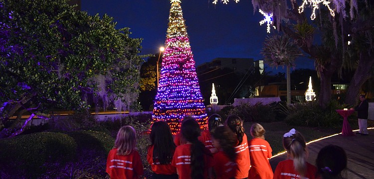The students from Girls Inc. of Sarasota County stare in awe of the tree.