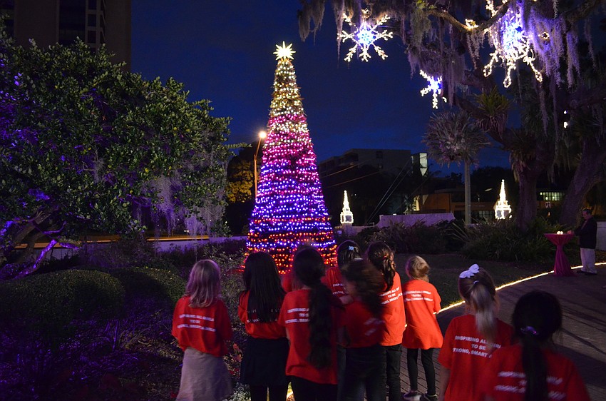 The students from Girls Inc. of Sarasota County stare in awe of the tree.