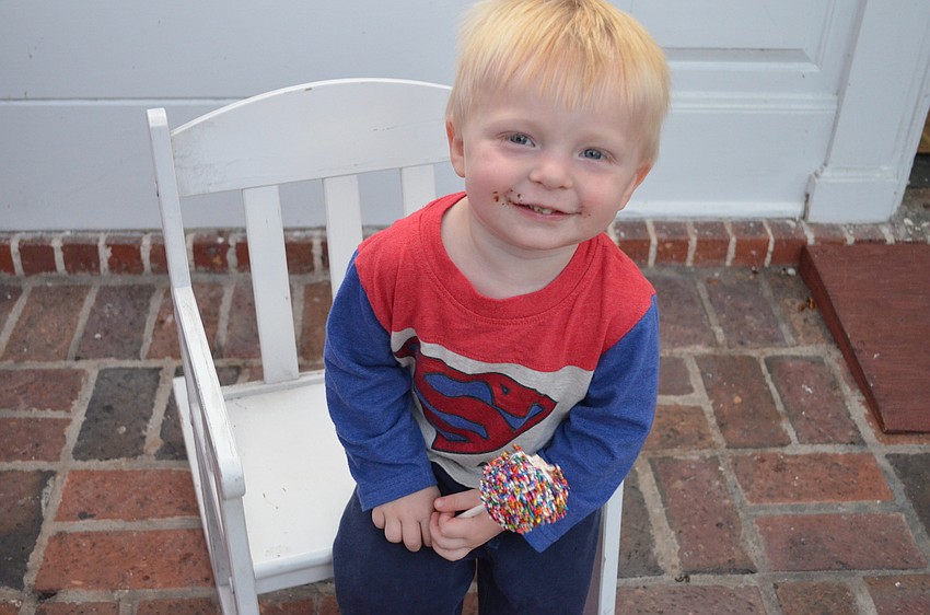 Liam Parker enjoys a marshmallow covered in sprinkles.
