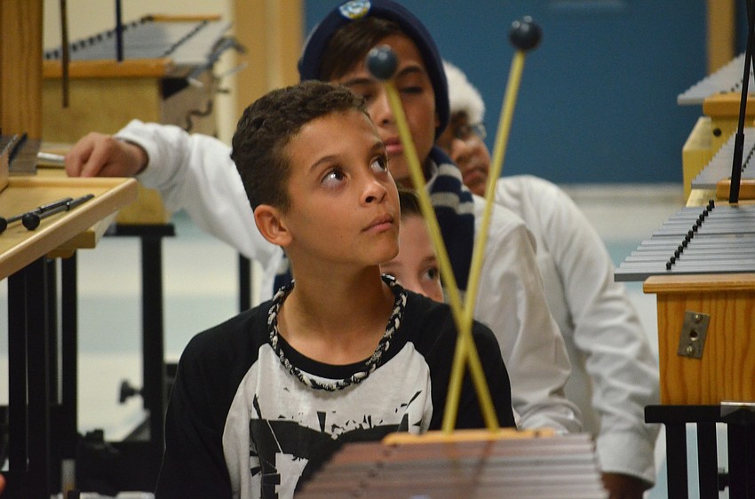 Clay Brown, of Bradenton, waits for his cue to play his instrument.
