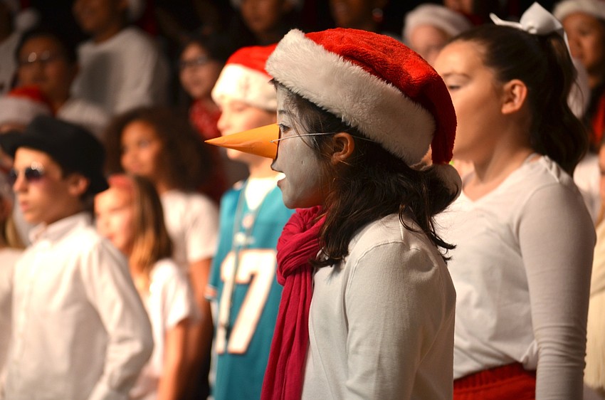 Gabriella Ramirez, of Bradenton, plays a snowman.