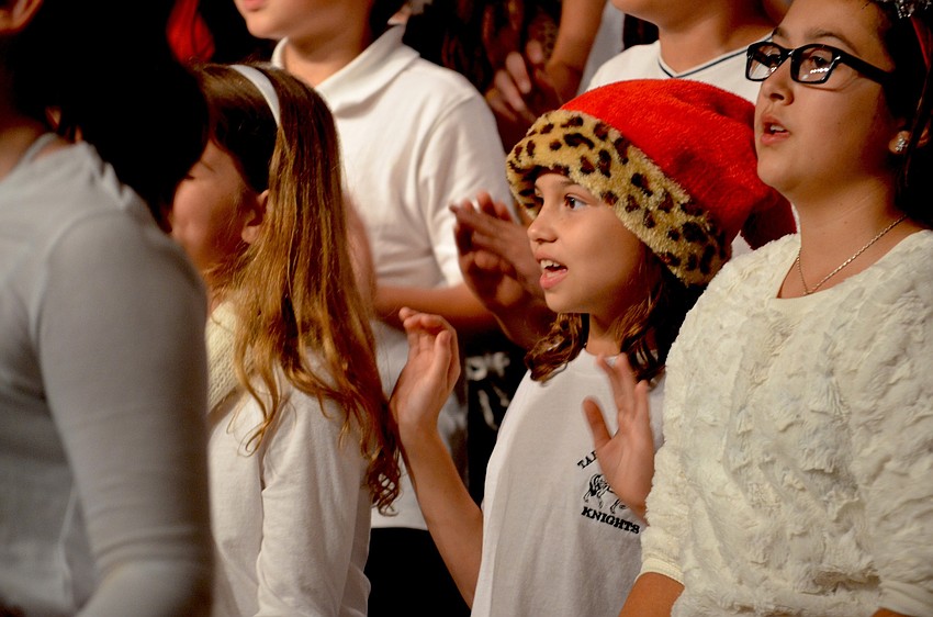 Olivia Gibson, of Bradenton, spices up her Santa hat with animal print.