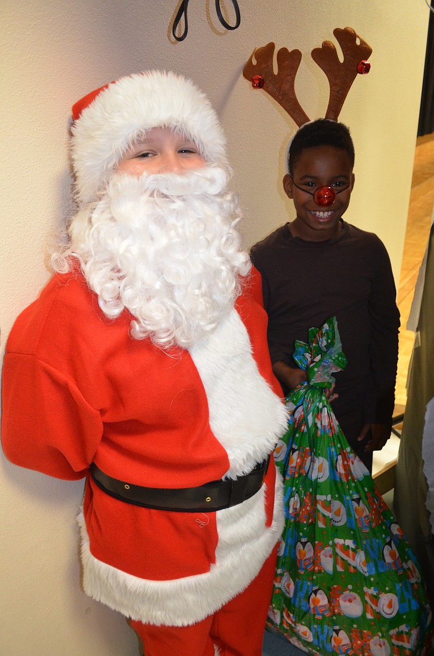 Bobby Pike and Malachi Brand, of Bradenton, play Santa Claus and Rudolph the reindeer.