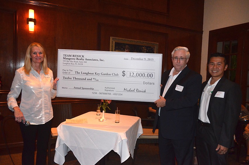 Mike Renick and Eric Teoh, right, present President Susan Phillips, left, with a $12,000 sponsorship check.