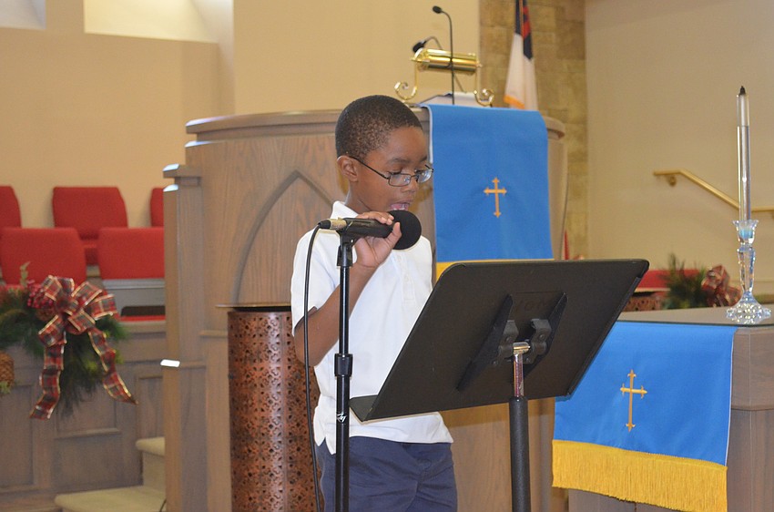 Jhilan Young, 8, speaks.