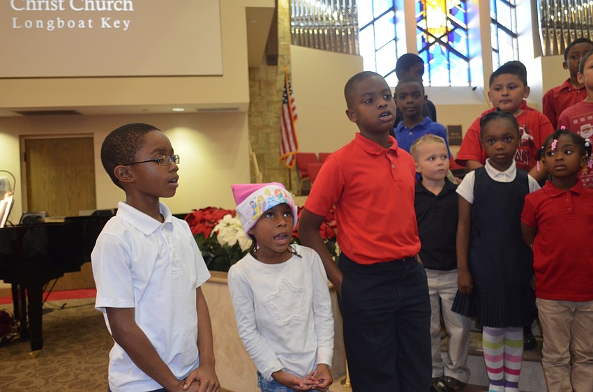Jhilan Young, 8, Aubrii Ferguson, 6, and Jonathan Robuste, 9, sing “Away in A Manger.”