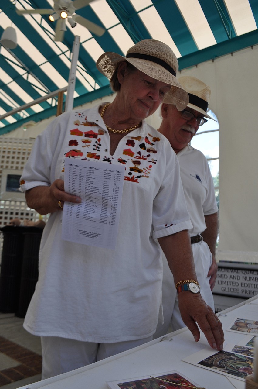 Marita Stepe, pictured with Olaf Maly, looks at homemade greeting cards.