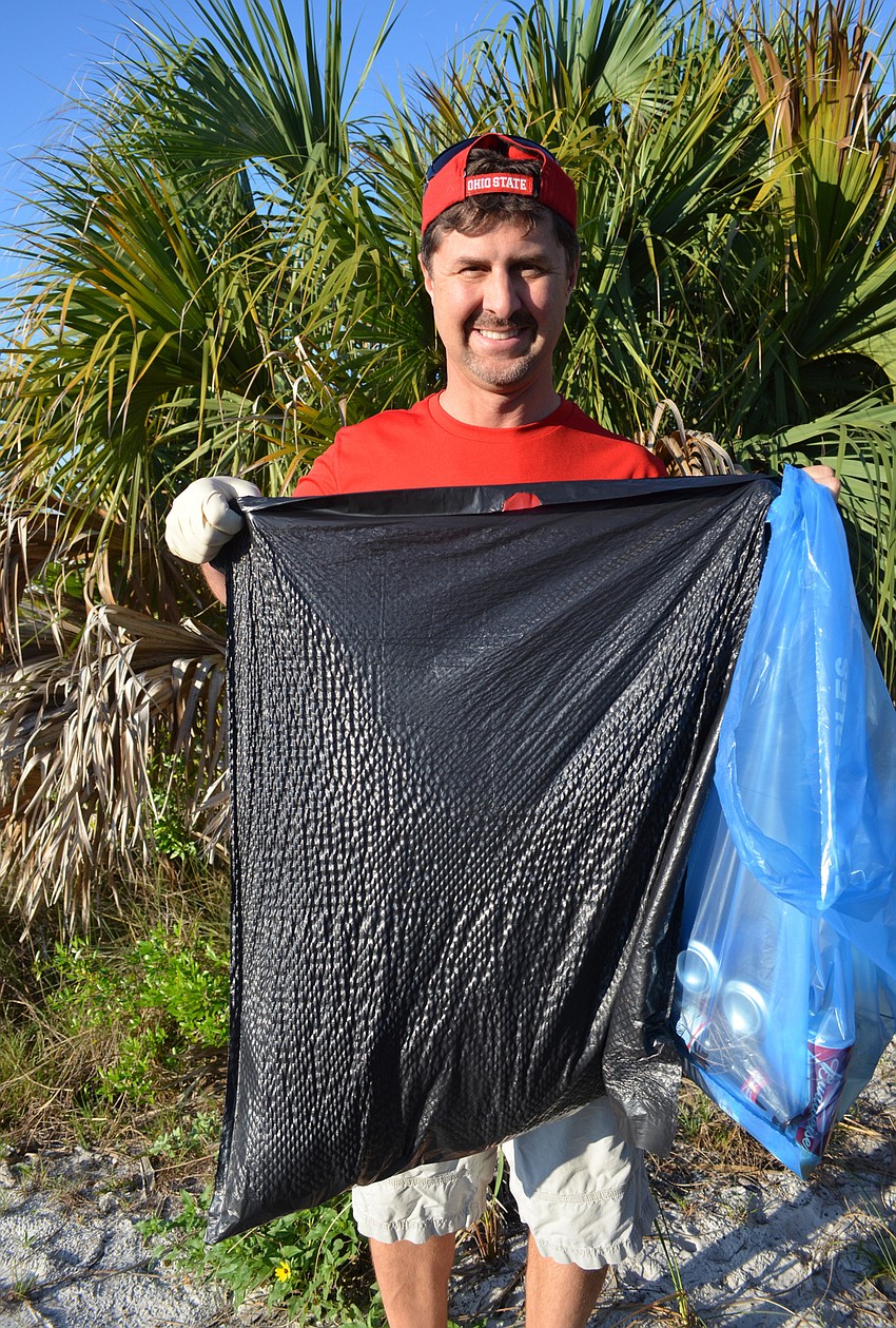 Chuck Pue with his trash bag almost full.