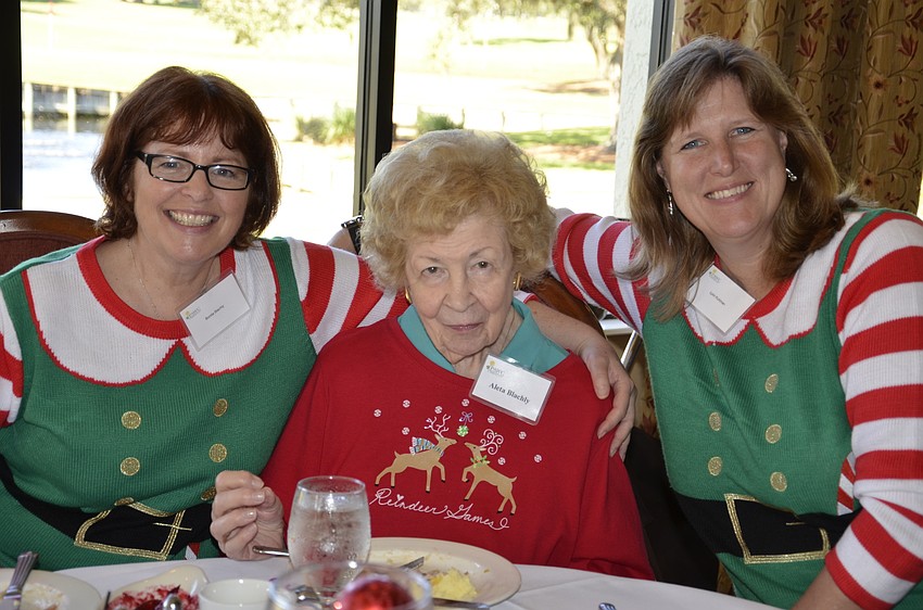 Aleta Blachly, center, attended the holiday luncheon with her two daughters visiting from Wisconsin, Bonita, left, and Lynn, right.