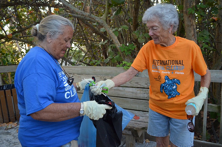 Putsie Ritchey and Cynthia Smyth search the walkways for any trash.