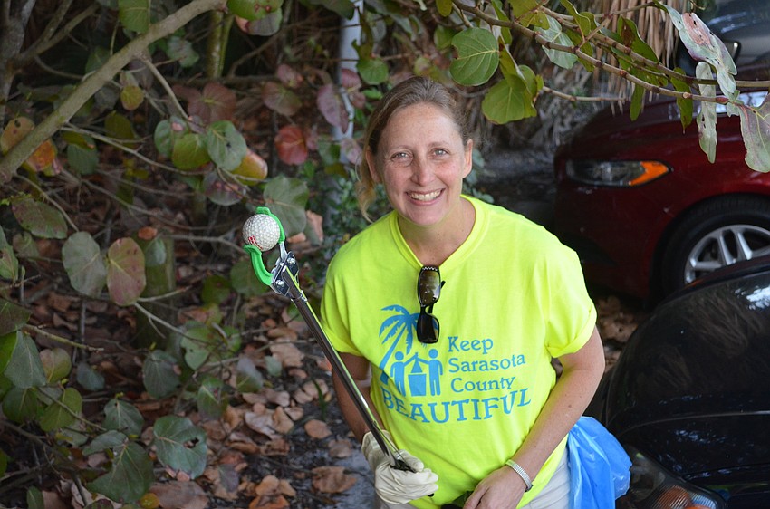 Terri Schubel found a golf ball near the parking lot during the cleanup on Saturday, March 21.