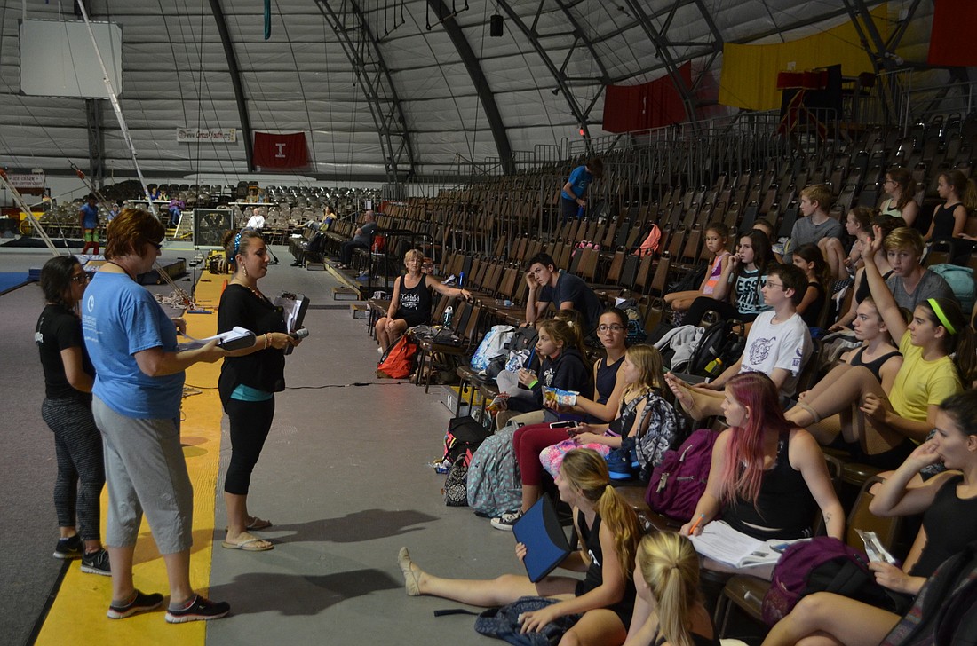 Emily Wyatt, coach and circus arts training program assistant, leads the more than 100 area students in a pre-practice meeting.