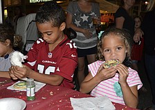 Lakewood Ranch kids Devin Raines, left, finishes up his cookie while Alexa Thornton, right, takes a bite. "It's good!" she said.