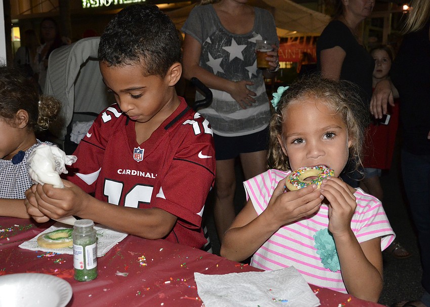Lakewood Ranch kids Devin Raines, left, finishes up his cookie while Alexa Thornton, right, takes a bite. 