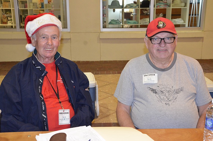 Lakewood Ranch residents LeRoy Smith and Dave Trick man the volunteer sign in area. Smith at first blamed his wife for making him volunteer, but he was joking — 