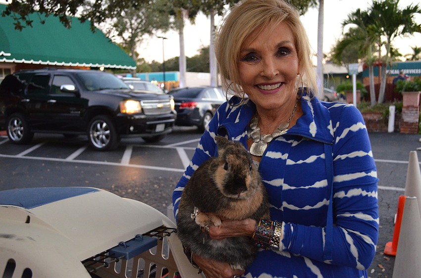 Sarasota in Defense of Animals President Elise Matthes cuddles with a bunny that is available to be adopted.