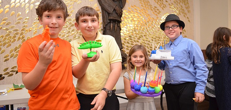 Sam and David Howard with Dani Mallitt and Garret Pearson and their menorahs.