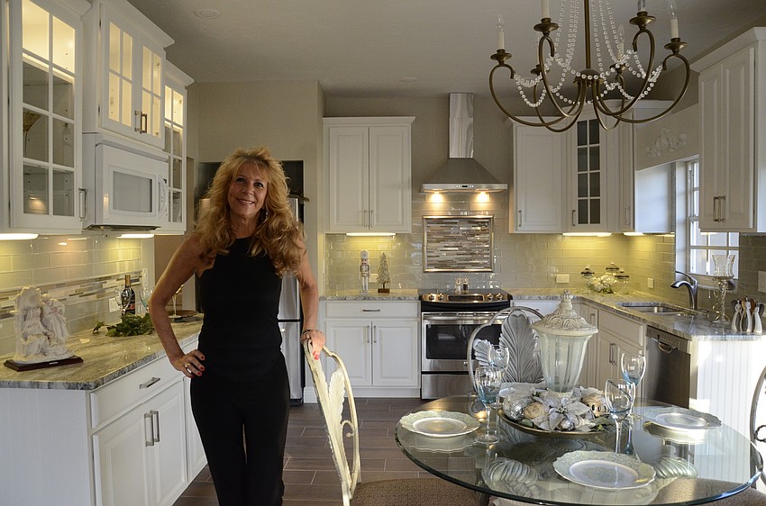 Lynda Contarino said one of her favorite parts of the new look is the kitchen: white wood cabinets with glass lit uppers and the glass tile backsplash tie in the coastal contemporary look of the rest of the home.