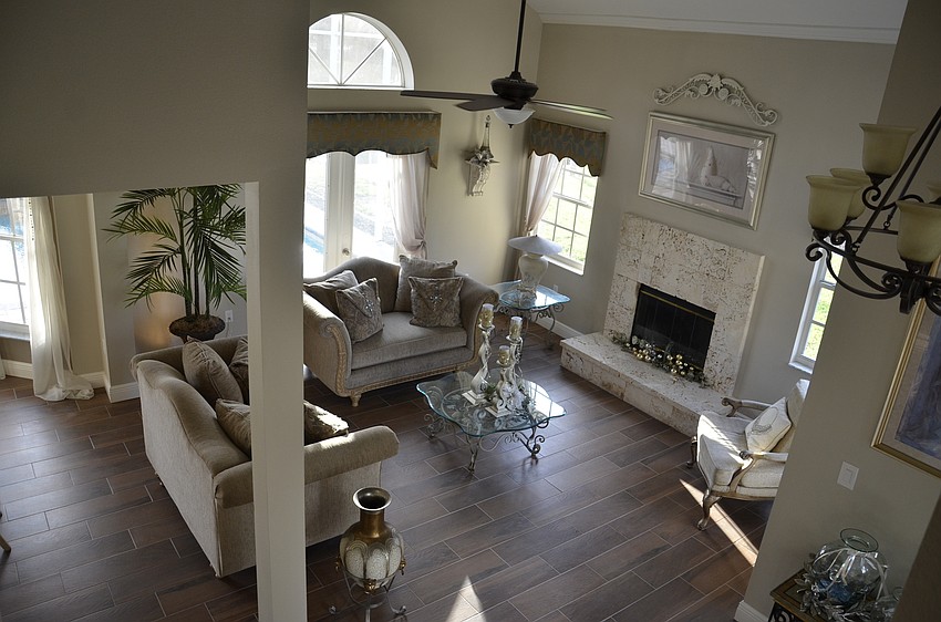 With a wall knockout, replacing carpet with wood-look tile and a paint job, the living and dining room area is a total remodel.