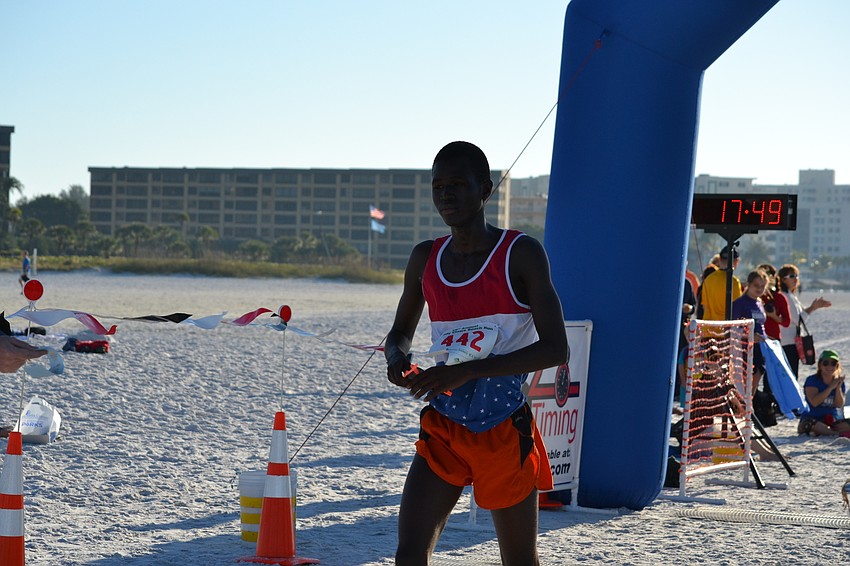 Overall winner Tony Wachira crosses the finish line.
