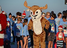 Rudolph the red-nosed reindeer gets in position for the start of the one-mile fun run.