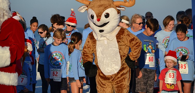 Rudolph the red-nosed reindeer gets in position for the start of the one-mile fun run.