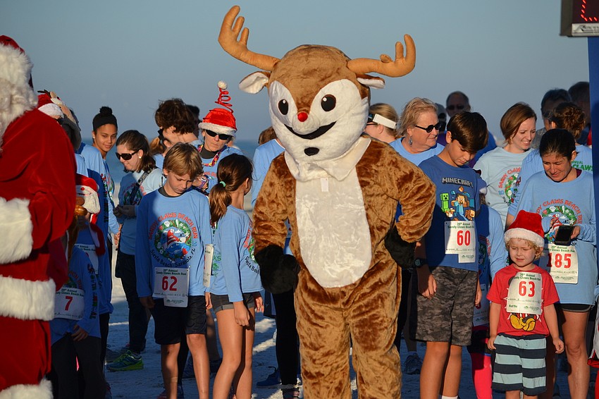 Rudolph the red-nosed reindeer gets in position for the start of the one-mile fun run.
