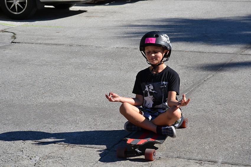 Gavin Clayton pretends to meditate on his board while warming up for the races.