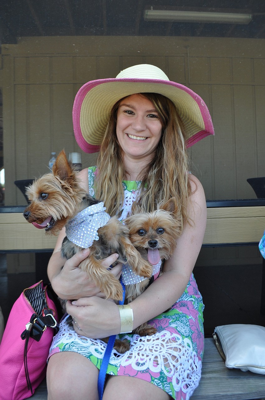 Muffy Lavens watches the match with her dogs, Pascal and Paris.