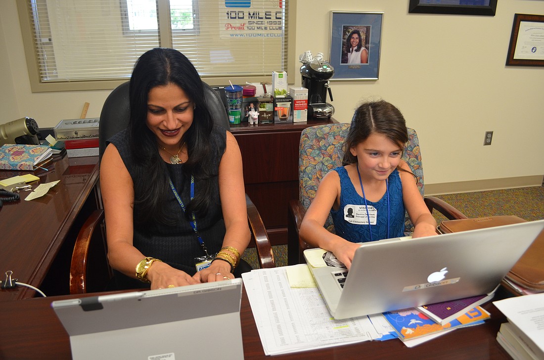 Gullett Principal Dr. Shirin Gibson catches up on some emails with her protege, Sunny Dwizinski.