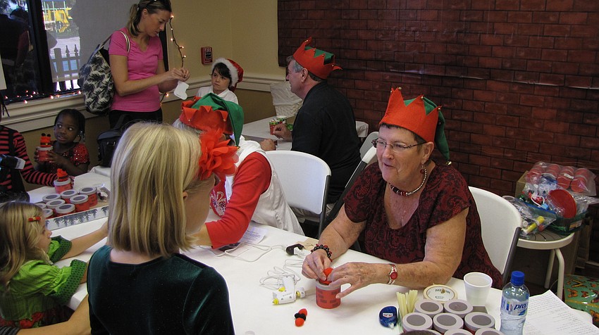 Phyllis Jameson helps children with crafts.