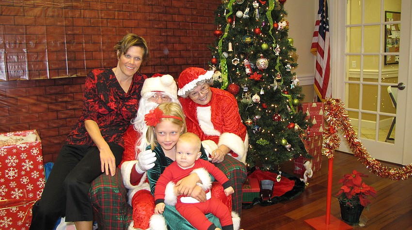 The Martin family — Jaime, Sara and Ryan — say cheese with Santa and Mrs. Claus.