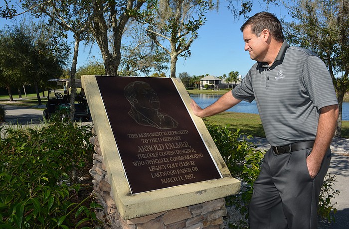 New owner Jon Whittemore reads a plaque dedicated to course designer Arnold Palmer at Legacy Golf Club of Lakewood Ranch.