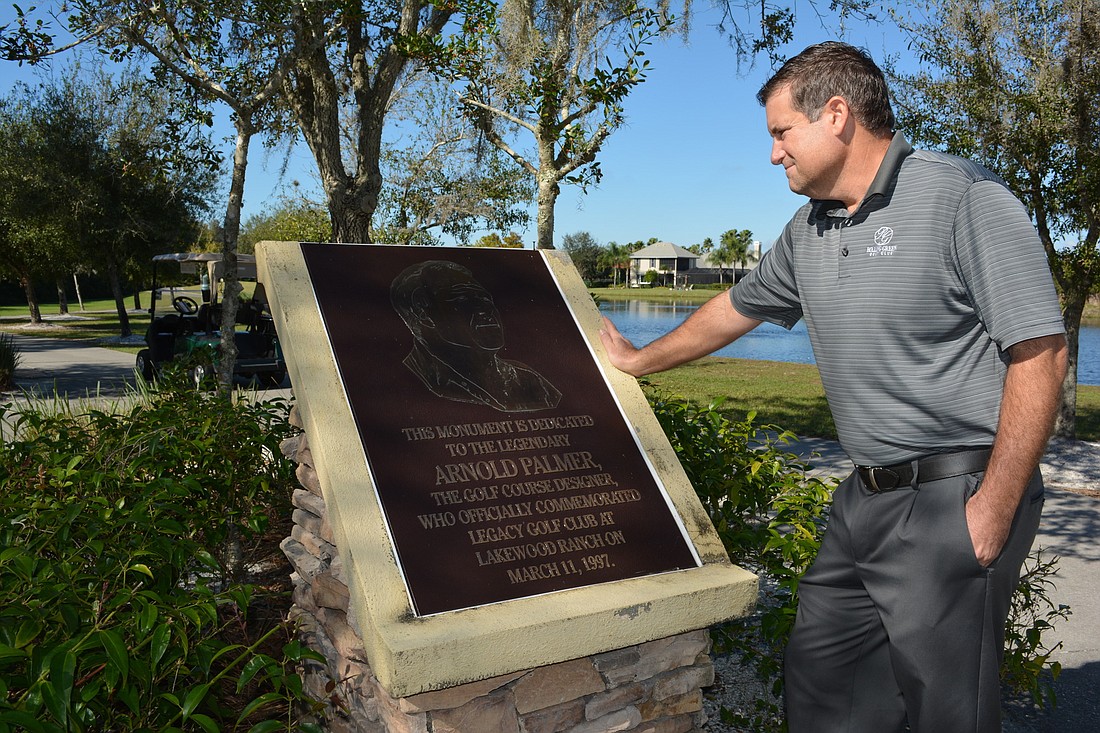 New owner Jon Whittemore reads a plaque dedicated to course designer Arnold Palmer at Legacy Golf Club of Lakewood Ranch.