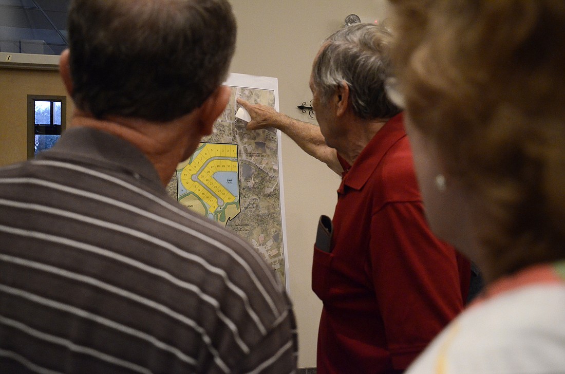 Fellow Braden Woods residents Ray Geisler and Gail and Tom Myers review Neal Communities concept plan of the 31-home subdivision. Since the developer has not yet applied to the county for the rezone, the concept plan is not solidified.