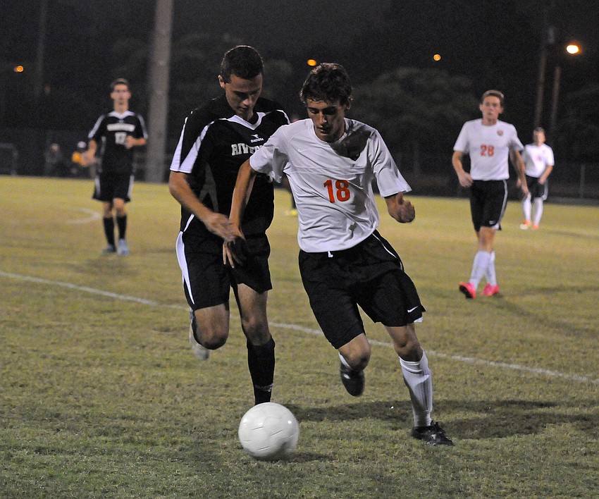 Sarasota's Bradley Gelb attempts to fight off Riverview's Ross Atkin.