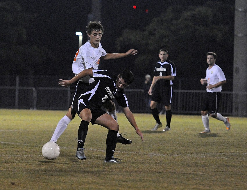 Sarasota's Bradley Gelb and Riverview's Adi Trifka battle for possession in the first half.