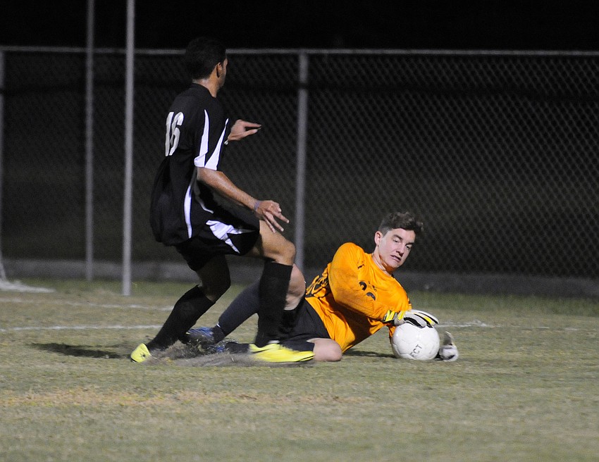 Sarasota goalkeeper Xander Couperus makes a stop for the Sailors.