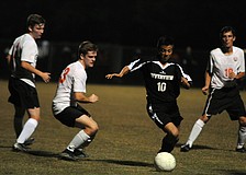 Riverview senior midfielder Felipe Rojas attempts to maneuver the ball around Sarasota's line of defense.