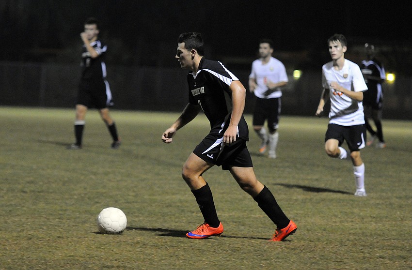 Riverview junior midfielder Christian Bosak pushes the ball up the field for the Rams.