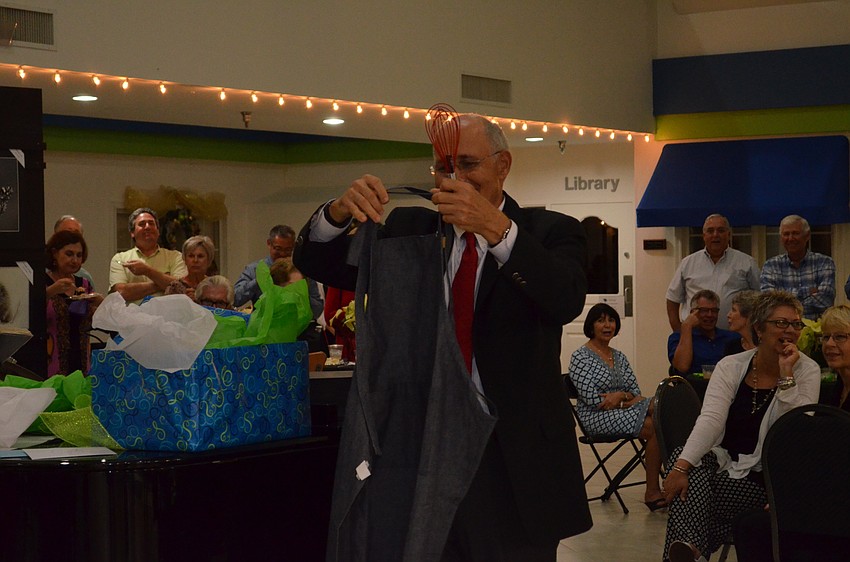 Friendship Centers staff members gave Bob Carter a whisk, an apron and private cooking lessons with Chef Paul Mattison.