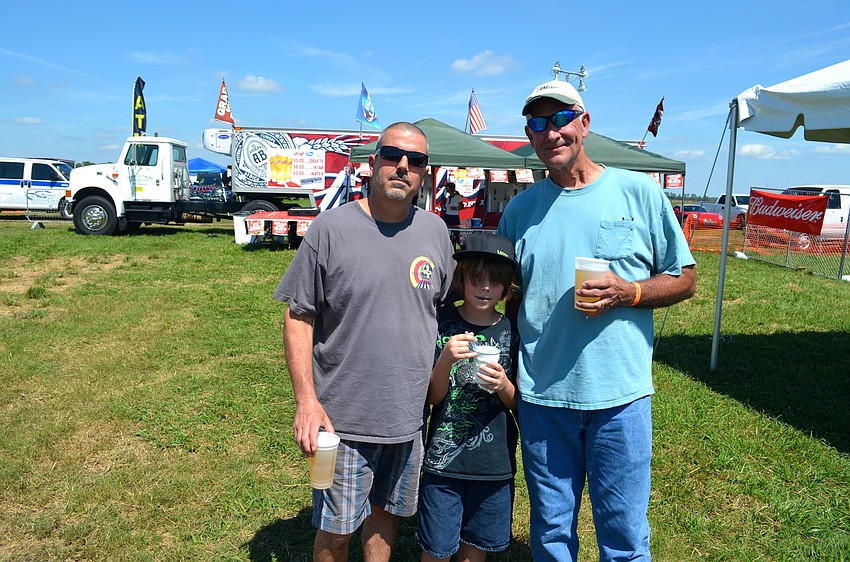 Jimmy Pollack and Nicholas Pollack, and Robert Wixson each enjoy a cold refreshment.