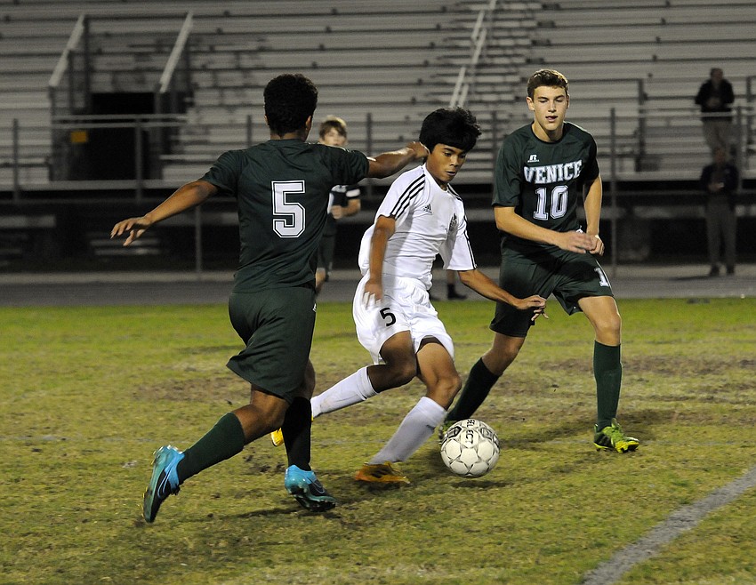 Braden River sophomore Kyle Villerante dribbles through a pair of Venice defenders in the first half.