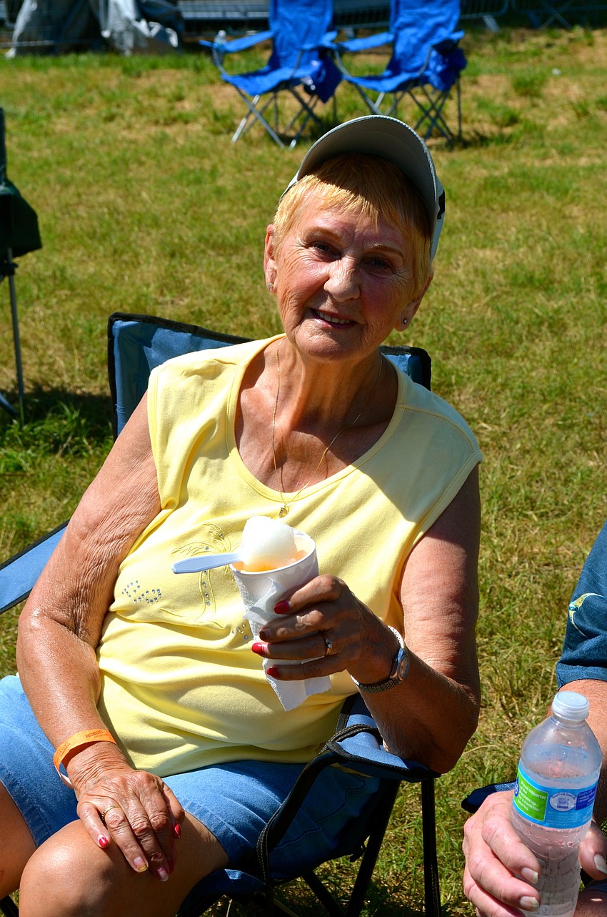 Darlene snacks on a snow cone to cool down on the hot spring day.