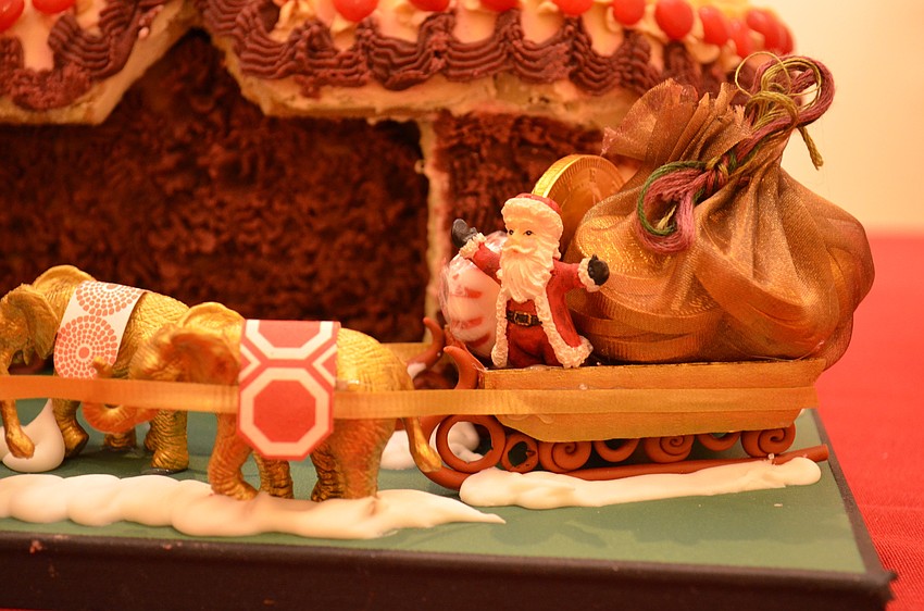 Santa's sled is led by a pack of elephants on the Circus Arts Conservatory gingerbread house.