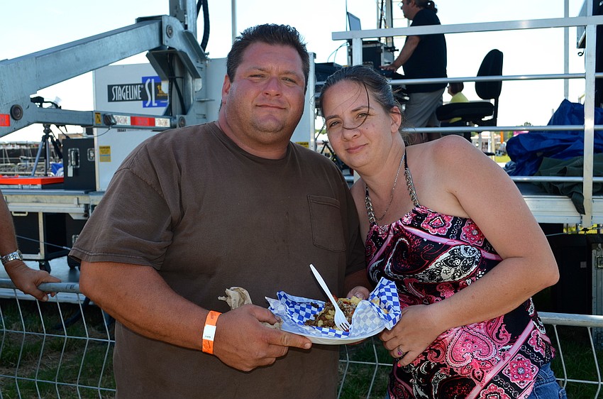 Chris and Erica Yeager enjoy country music, while snacking on fried food.