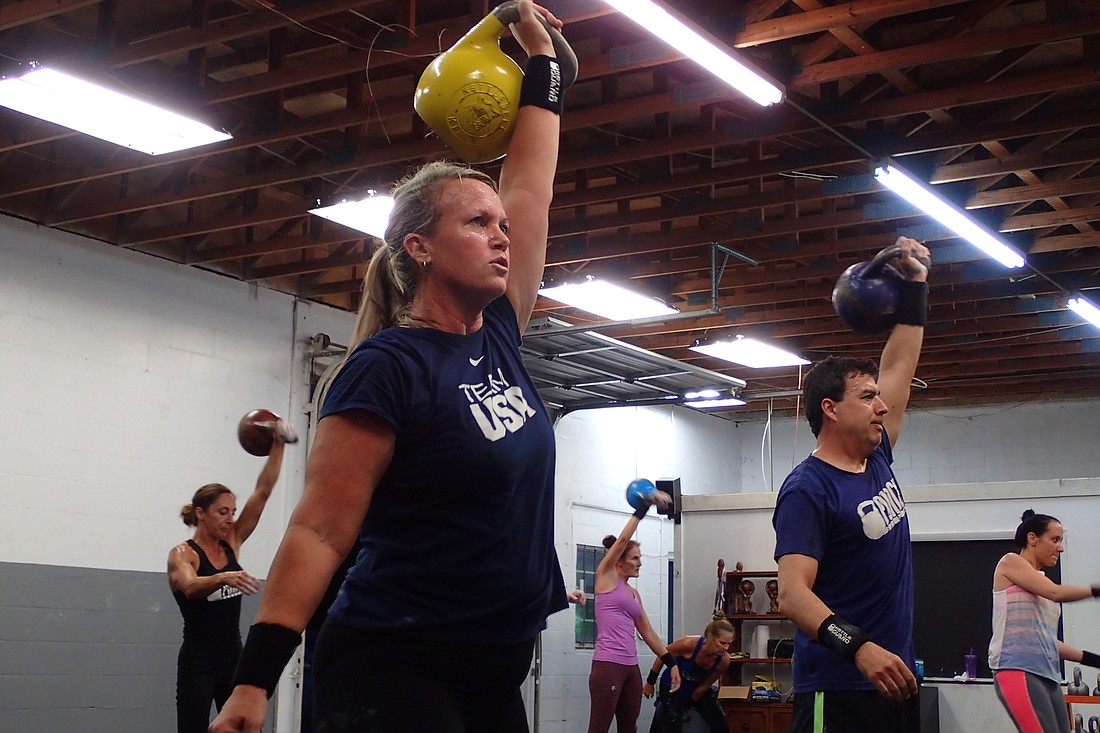 Teri Stabler, now an international champion kettlebell athlete, works out at Punch Kettlebell Gym in Sarasota. She will begin preparations to compete in professional divisions.