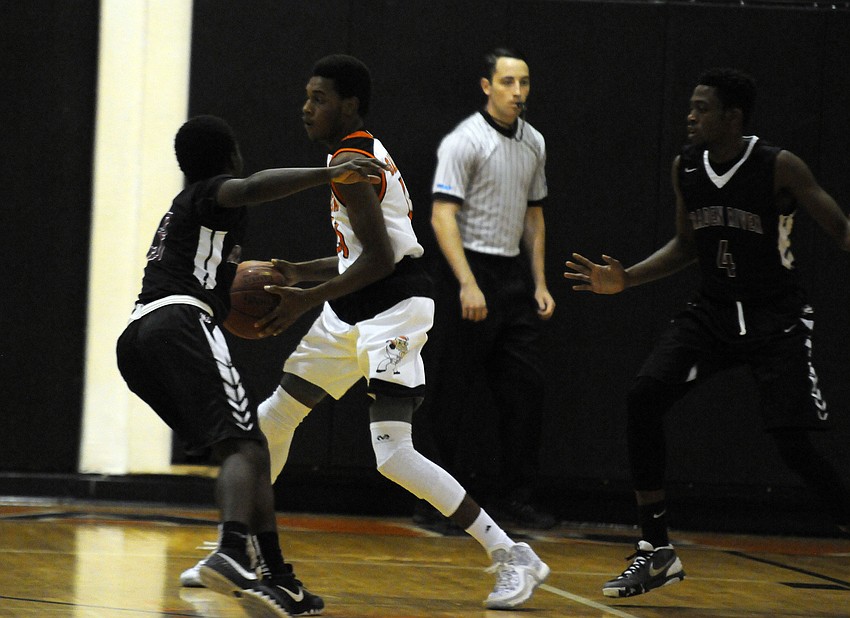 Sarasota's Adrian Langston searches the floor for an open teammate.